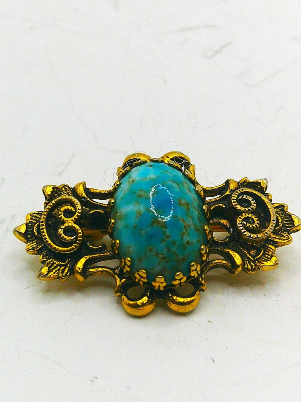 Baroque Brooch With Turquoise Colored Mottled Center & Gilt Setting